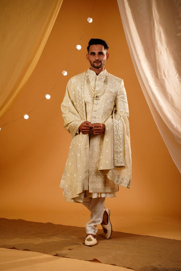 Golden floral thread embellished sherwani with matching bottom and beautiful handwork dupatta